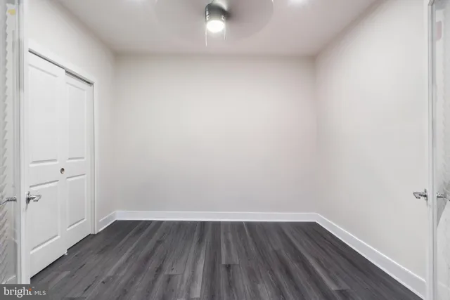 a view of a small space with wooden floor and a window