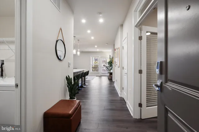 a view of a hallway with wooden floor and glass door