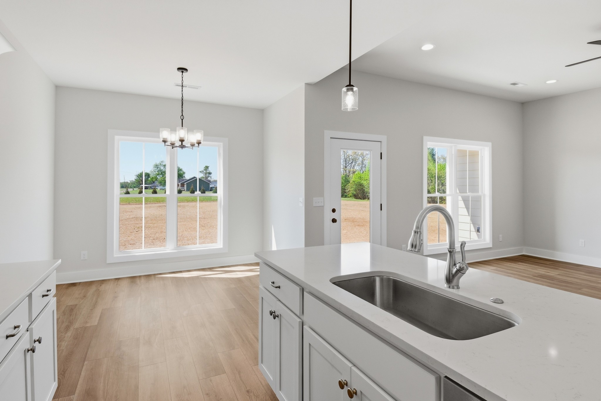 4335 Bybee Branch Road McMinnville, TN 37110 - Photo 11 of 25 a kitchen with kitchen island a sink wooden floor and a large window