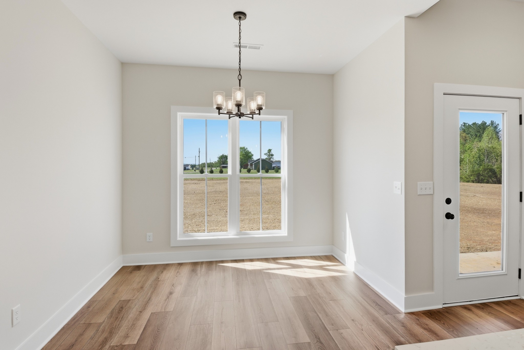 4335 Bybee Branch Road McMinnville, TN 37110 - Photo 12 of 25 a view of empty room with wooden floor and fan
