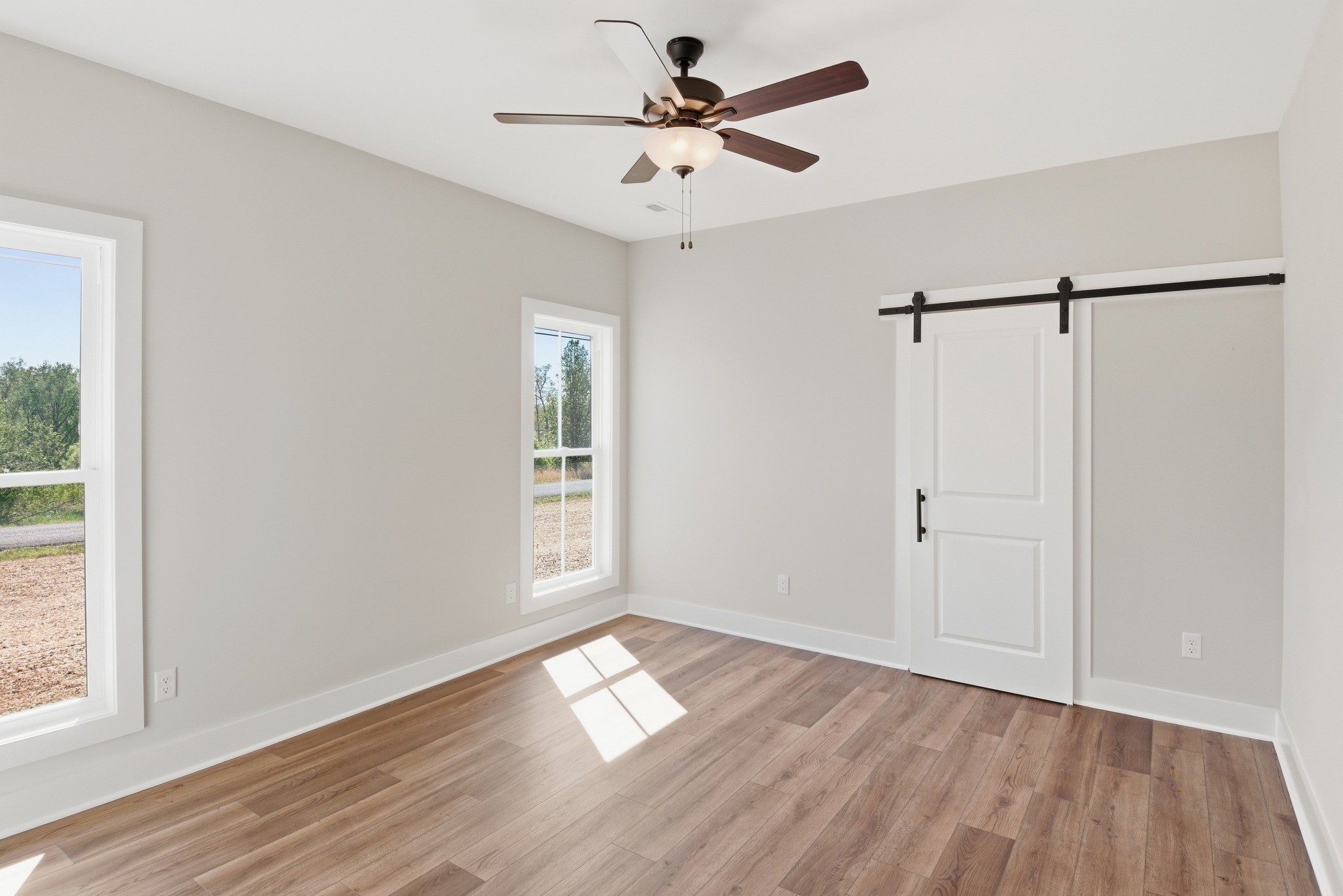 4335 Bybee Branch Road McMinnville, TN 37110 - Photo 13 of 25 a view of empty room with wooden floor and fan