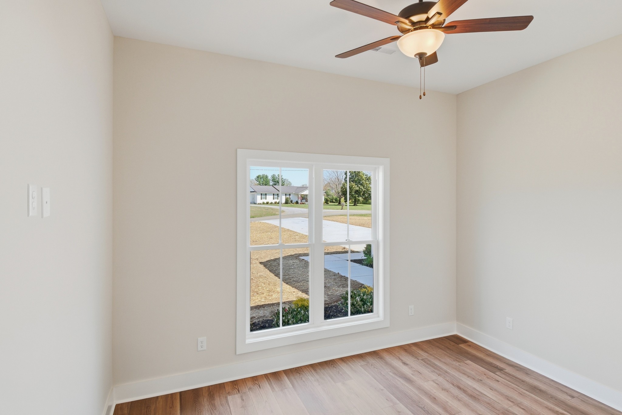 4335 Bybee Branch Road McMinnville, TN 37110 - Photo 17 of 25 an empty room with wooden floor fan and windows