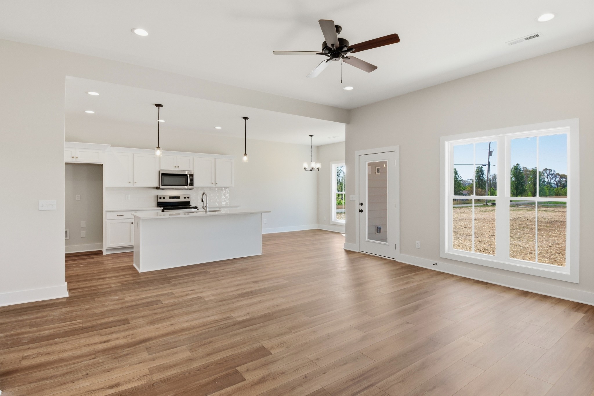 4335 Bybee Branch Road McMinnville, TN 37110 - Photo 3 of 25 a view of kitchen with stainless steel appliances kitchen island wooden floors and white cabinets