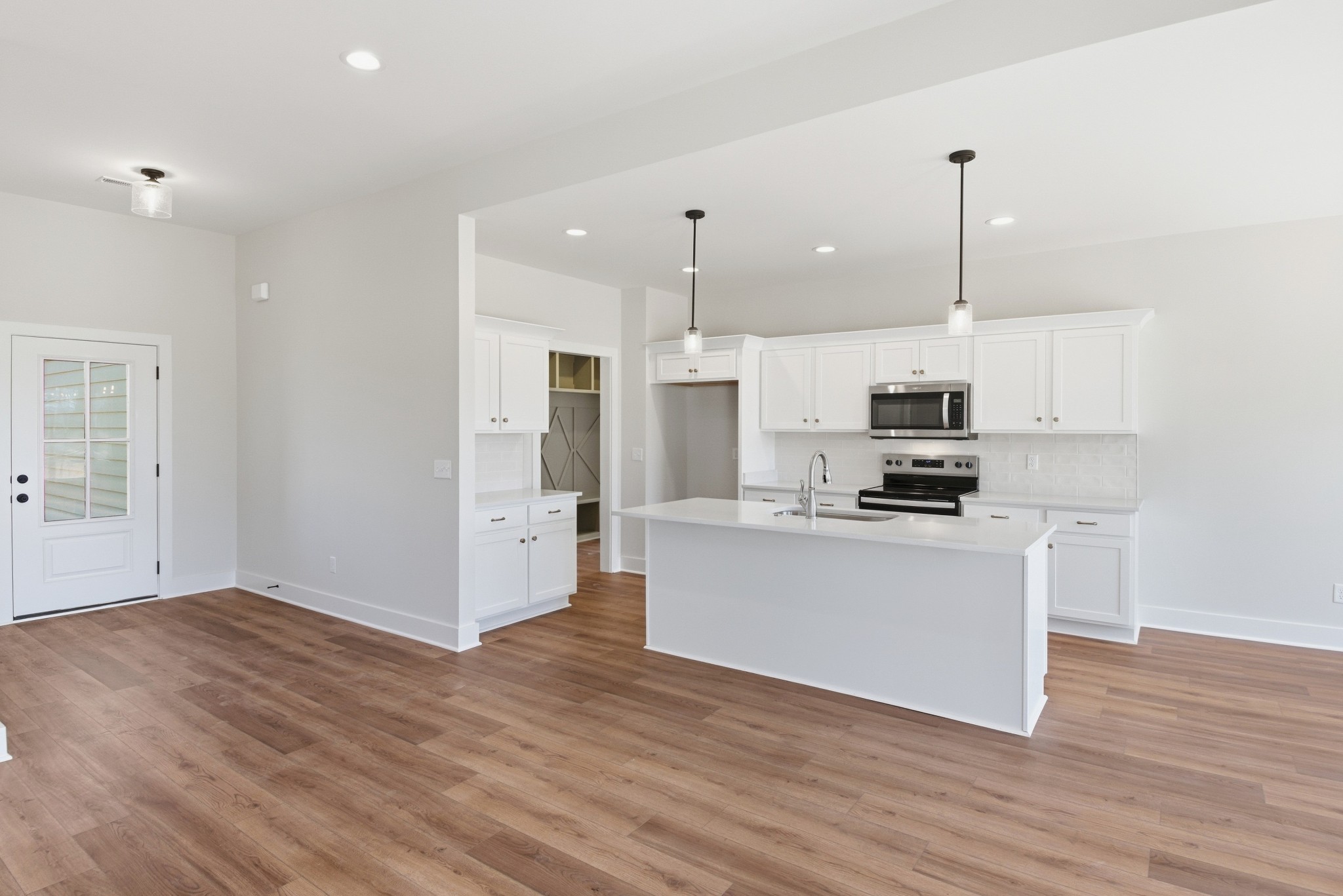 4335 Bybee Branch Road McMinnville, TN 37110 - Photo 6 of 25 a kitchen with stainless steel appliances granite countertop a refrigerator a stove a sink and white cabinets with wooden floor