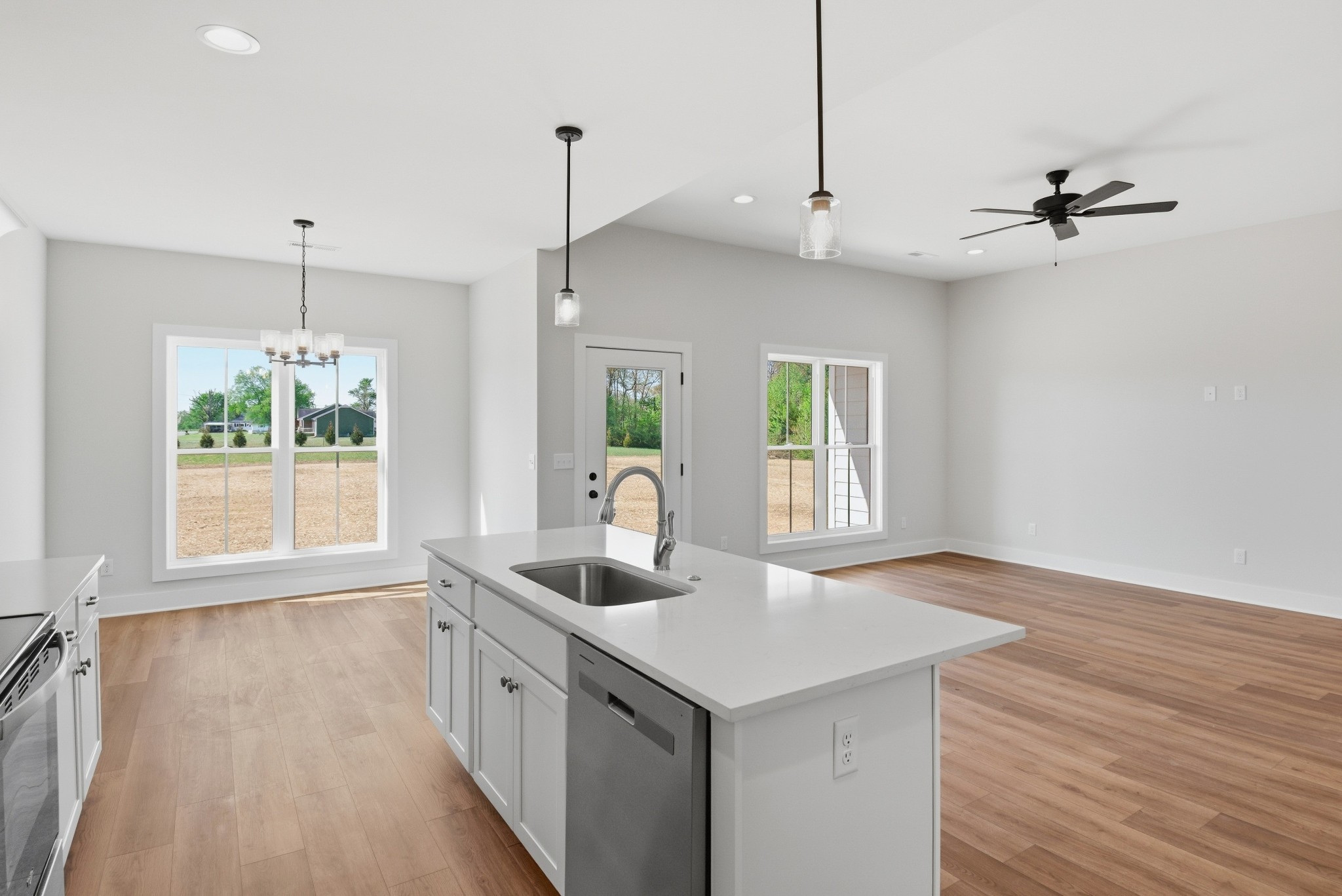 4335 Bybee Branch Road McMinnville, TN 37110 - Photo 8 of 25 a kitchen with stainless steel appliances granite countertop a sink a counter space wooden floor and a window