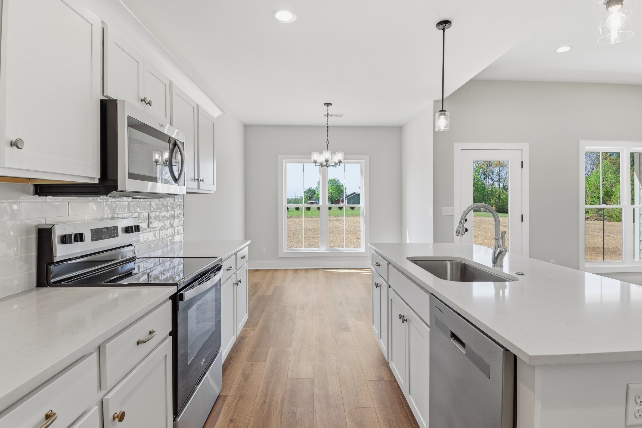 4335 Bybee Branch Road McMinnville, TN 37110 - Photo 10 of 25 a kitchen with stainless steel appliances granite countertop a sink a stove and a wooden floors