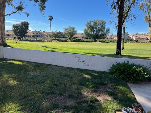 1085 Pauma Valley Road Banning, CA 92220 - Photo 17 of 18 a view of a swimming pool with a yard and palm trees