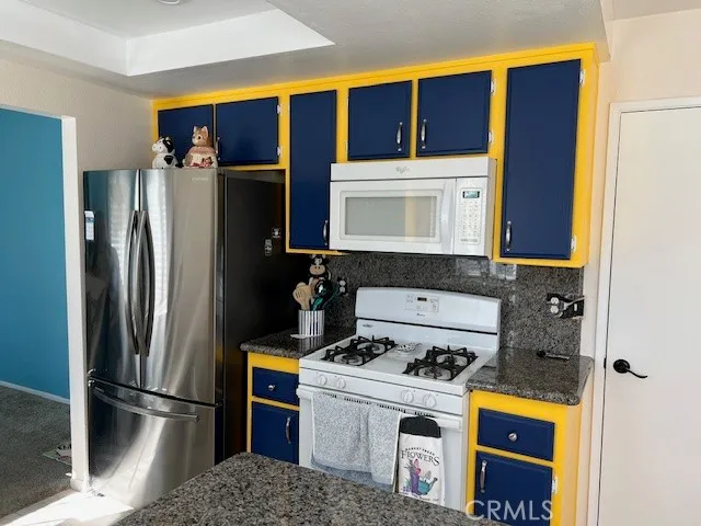 a kitchen with a refrigerator and a stove