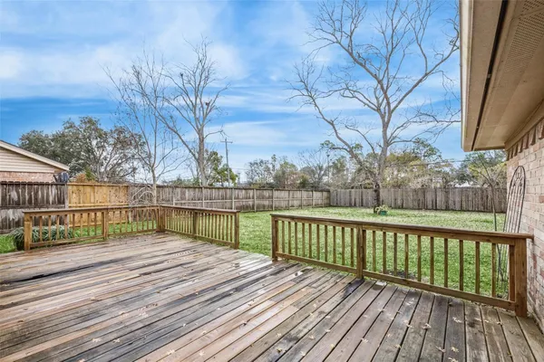 a view of balcony with wooden floor and fence
