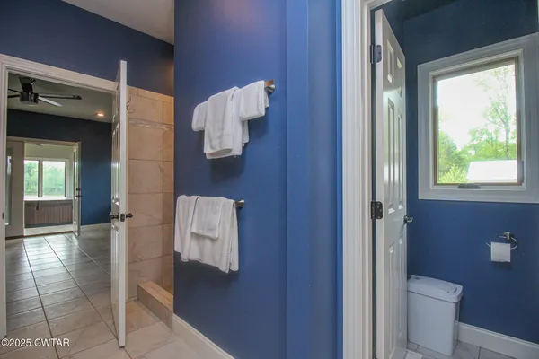 a bathroom with a toilet and a shower