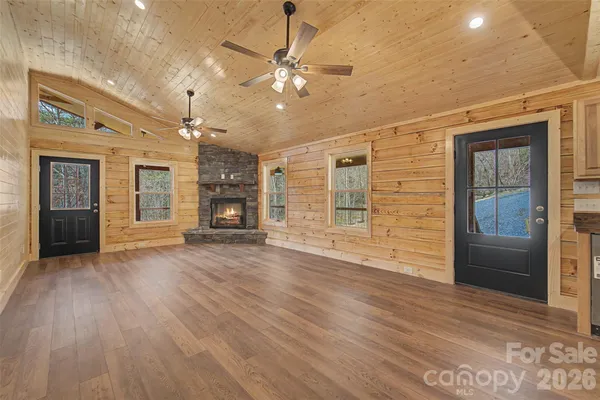 a view of an empty room with a fireplace and a window