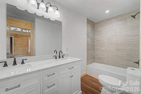 a view of an empty room and wooden floor