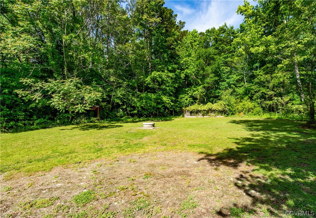 5800 Newbys Bridge Road Chesterfield, VA 23832 - Photo 25 of 29 a view of an swimming pool and trees in the background