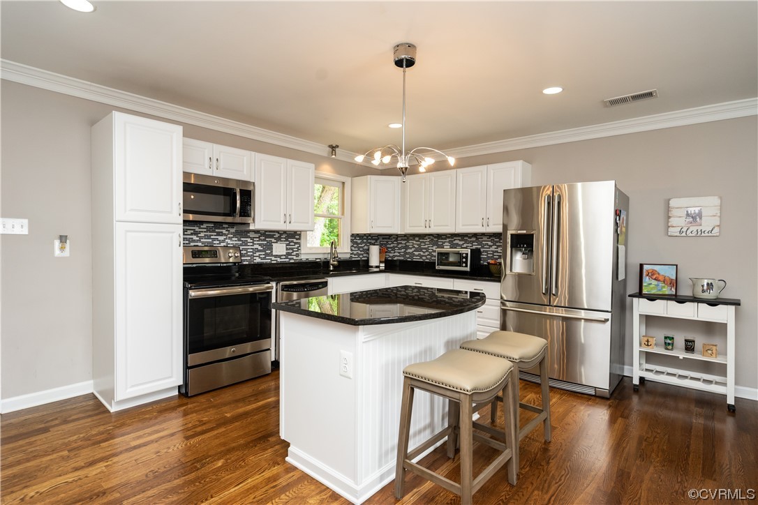 5800 Newbys Bridge Road Chesterfield, VA 23832 - Photo 8 of 29 a kitchen with granite countertop a refrigerator a stove a sink dishwasher a dining table and chairs with wooden floor