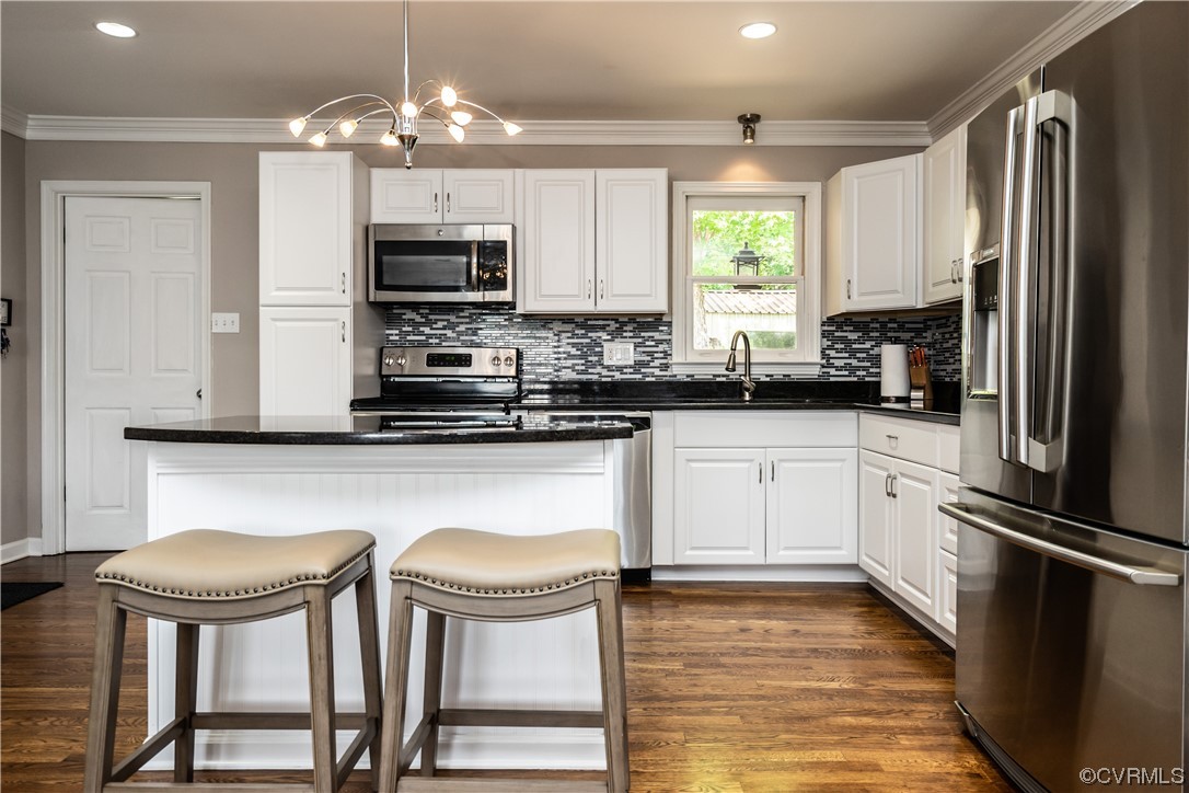 5800 Newbys Bridge Road Chesterfield, VA 23832 - Photo 9 of 29 a kitchen with stainless steel appliances granite countertop a stove a refrigerator and a microwave oven with wooden floor