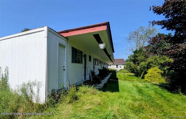 a cabinet with painting on wall and a painting on the wall