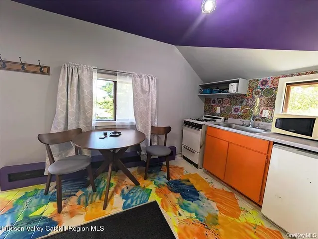 a view of a house with a yard and potted plants