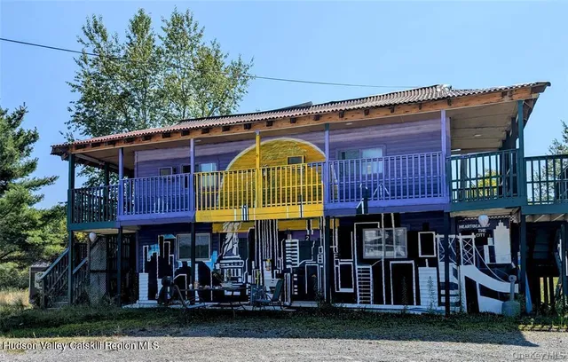 a view of balcony with wooden floor and outdoor seating