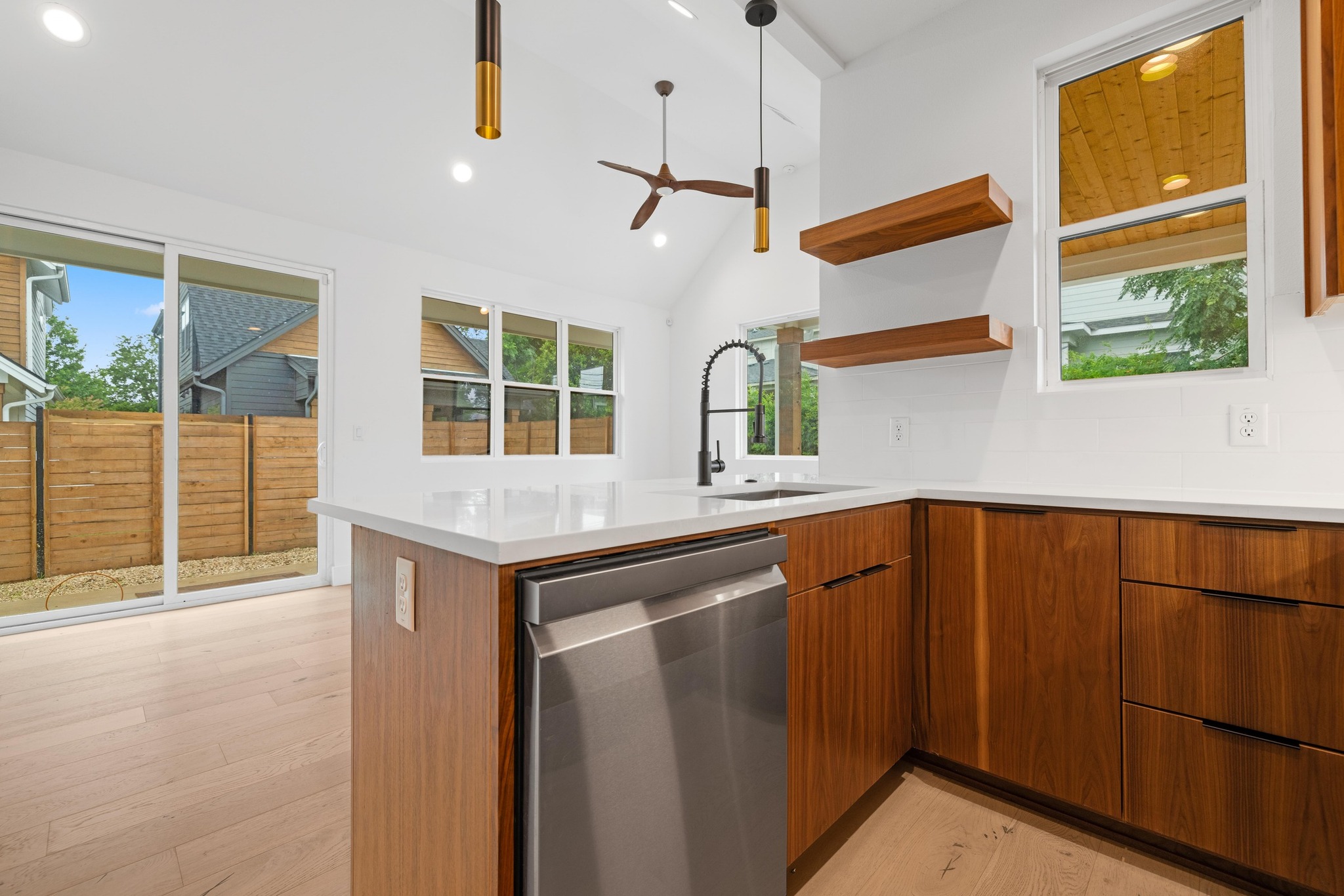 7706 Watson Street, Unit 2 Austin, TX 78757 - Photo 11 of 13 a kitchen with stainless steel appliances granite countertop a sink and a refrigerator