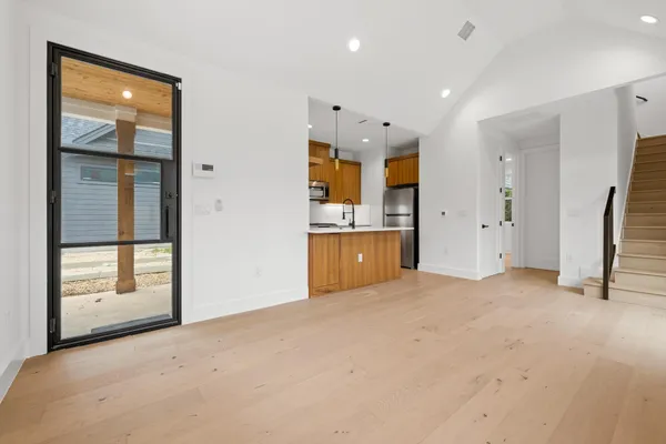 an empty room with windows and entrance