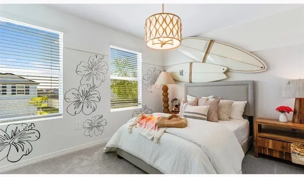 a bedroom with a bed and a chandelier