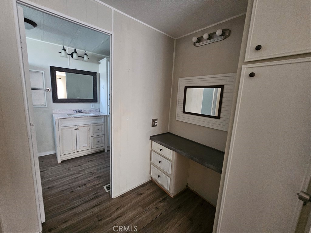 999 South Santa Fe Avenue, Unit 86 San Jacinto, CA 92583 - Photo 17 of 23 a bathroom with a sink a mirror and a toilet