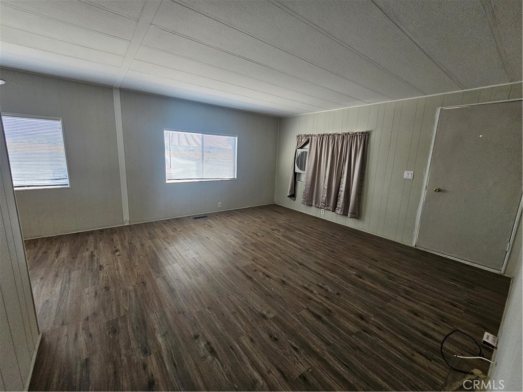 999 South Santa Fe Avenue, Unit 86 San Jacinto, CA 92583 - Photo 22 of 23 an empty room with wooden floor and windows