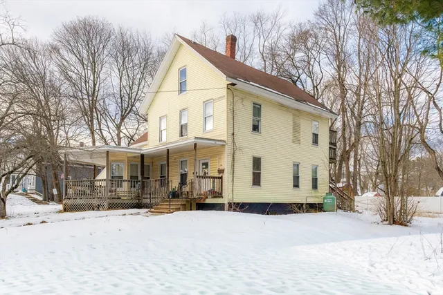 a view of a house with snow on the road