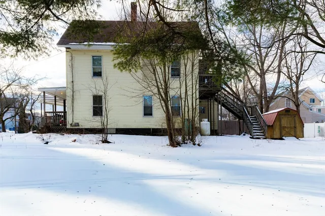 a view of a house with a snow in the yard