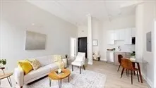 a living room with furniture a dining table and a fireplace