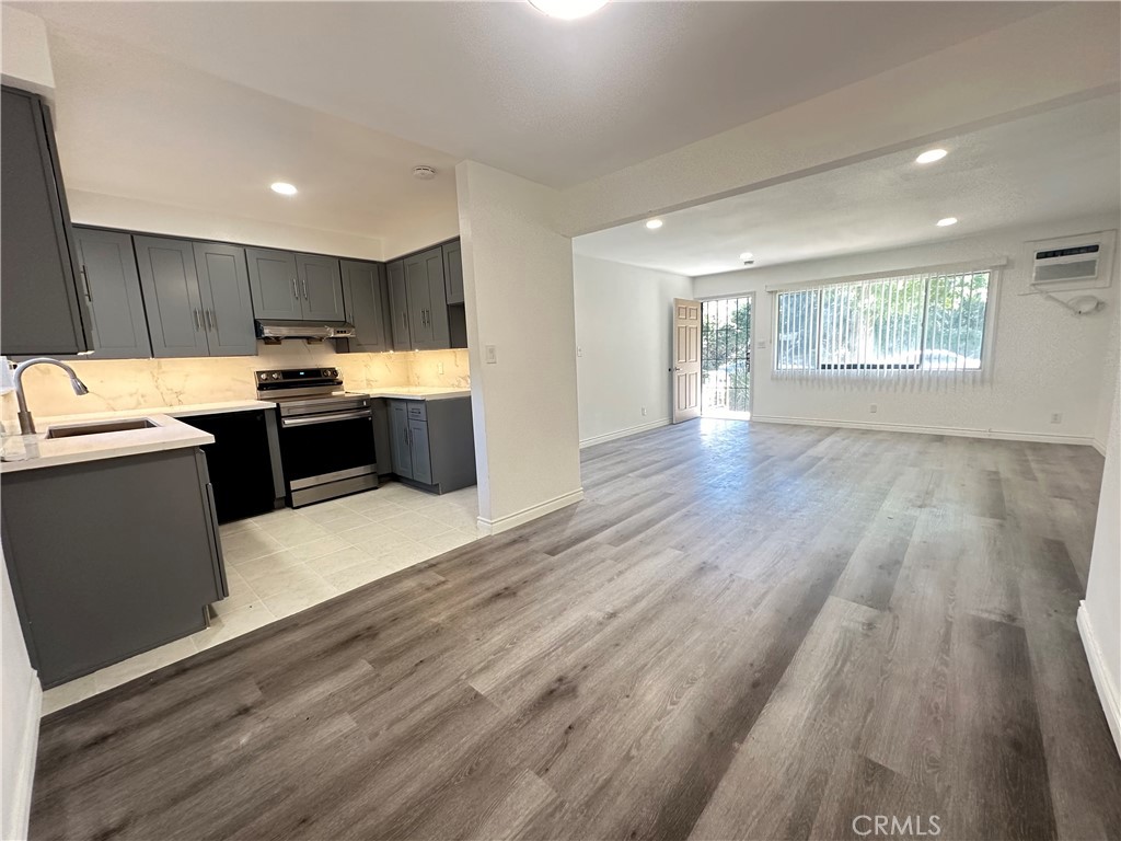 515 Fairview Avenue, Unit 3 Arcadia, CA 91007 - Photo 2 of 11 a kitchen with kitchen island wooden floors and stainless steel appliances