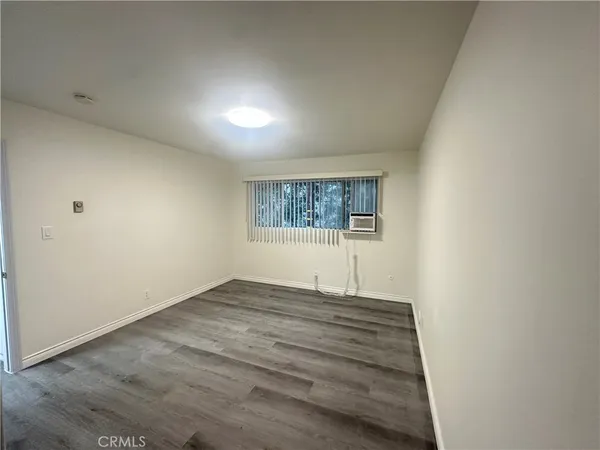 a view of an empty room and wooden floor