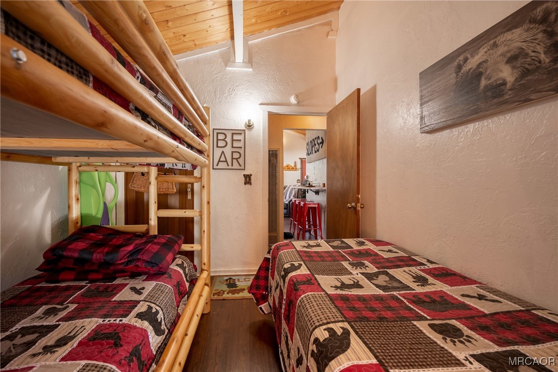 742 Cedar Lane Sugarloaf, CA 92386 - Photo 12 of 22 a bedroom with a bed and wooden floor