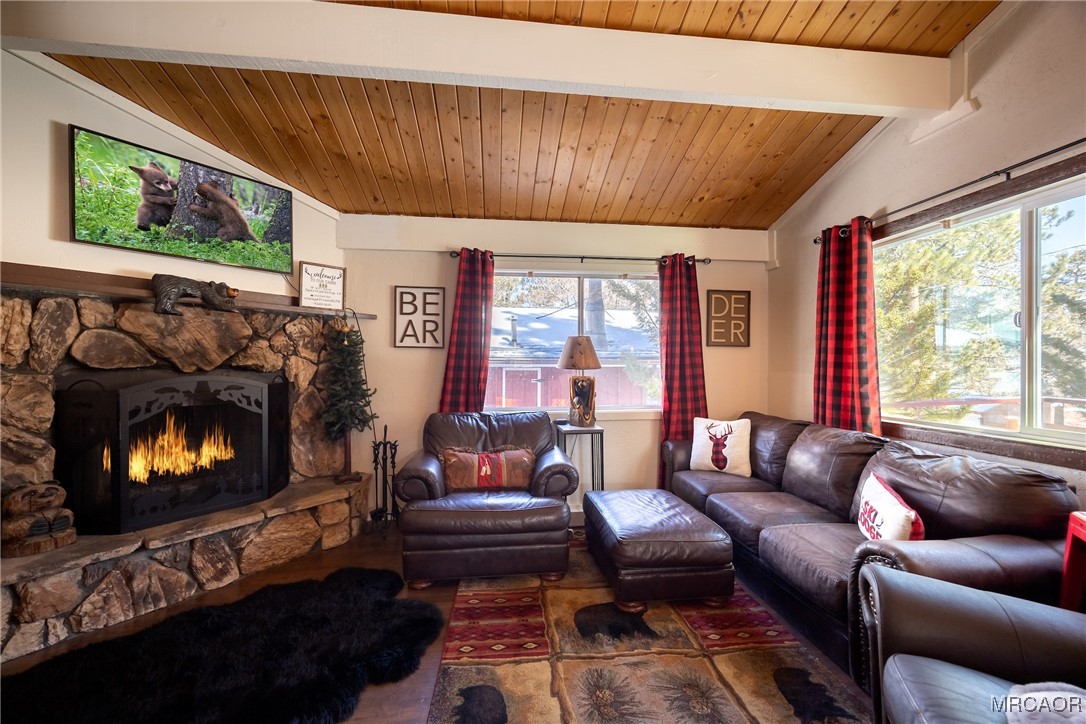 742 Cedar Lane Sugarloaf, CA 92386 - Photo 3 of 22 a living room with furniture a flat screen tv and a fireplace