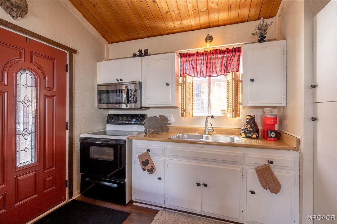 742 Cedar Lane Sugarloaf, CA 92386 - Photo 8 of 22 a kitchen with stainless steel appliances granite countertop a sink a stove and cabinets