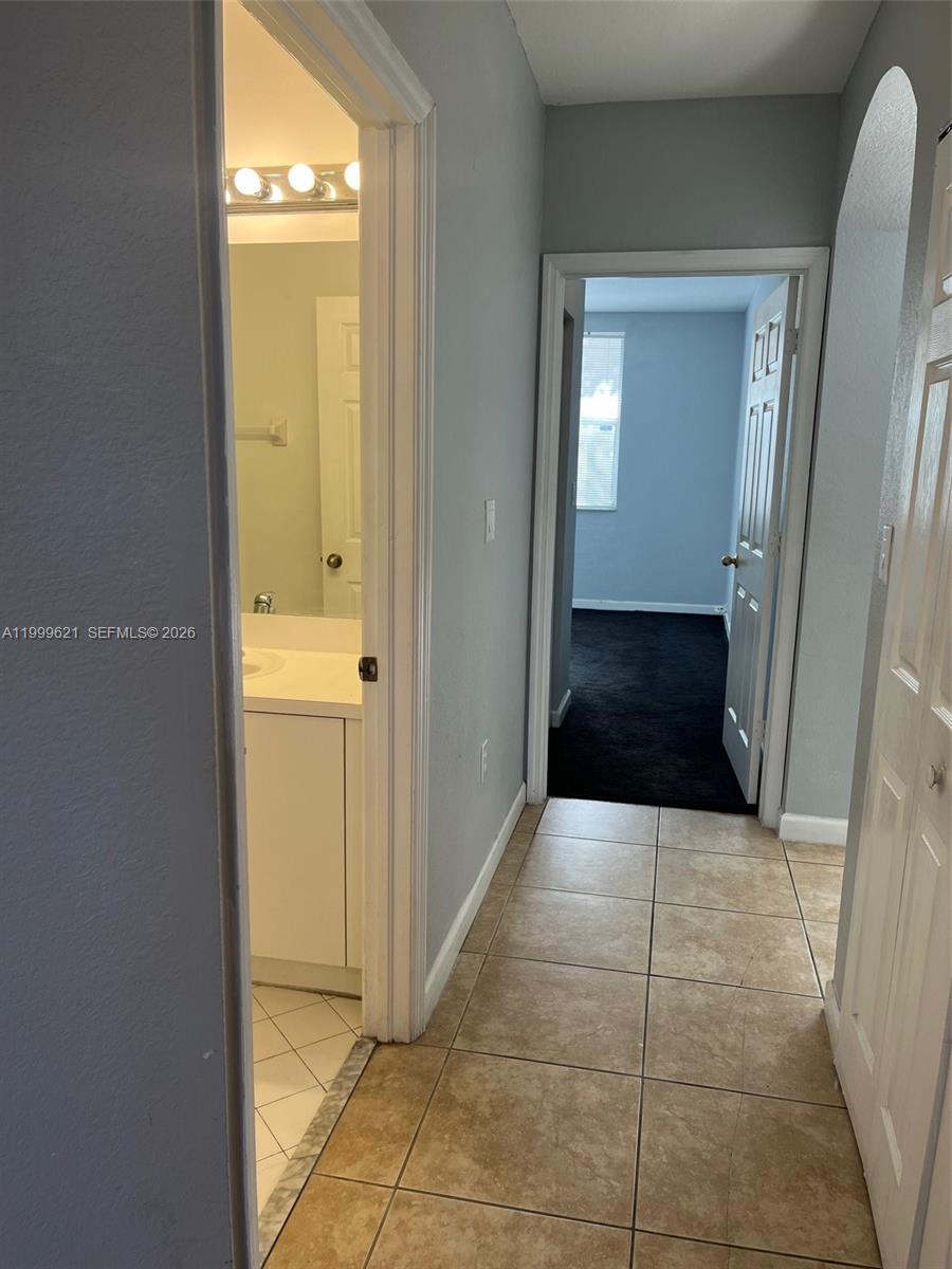 1650 Northeast 33rd Road, Unit 10610 Homestead, FL 33033 - Photo 11 of 22 a view of a hallway with some storage and utility room
