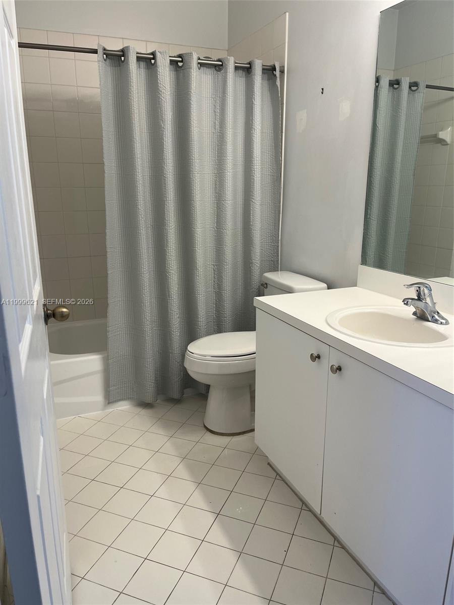 1650 Northeast 33rd Road, Unit 10610 Homestead, FL 33033 - Photo 14 of 22 a bathroom with a sink a toilet and shower