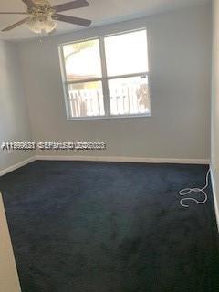 1650 Northeast 33rd Road, Unit 10610 Homestead, FL 33033 - Photo 15 of 22 an empty room with wooden floor and windows