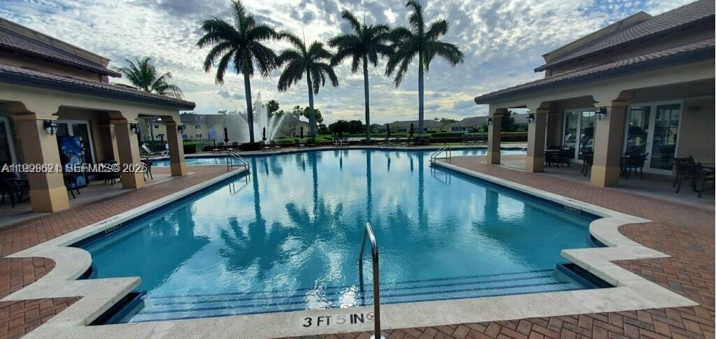 1650 Northeast 33rd Road, Unit 10610 Homestead, FL 33033 - Photo 22 of 22 a swimming pool with outdoor seating