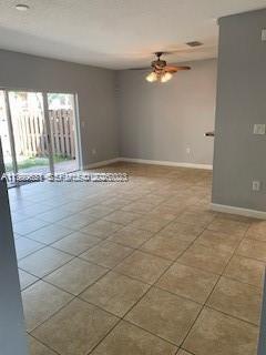 1650 Northeast 33rd Road, Unit 10610 Homestead, FL 33033 - Photo 4 of 22 a view of an empty room and window & kitchen area