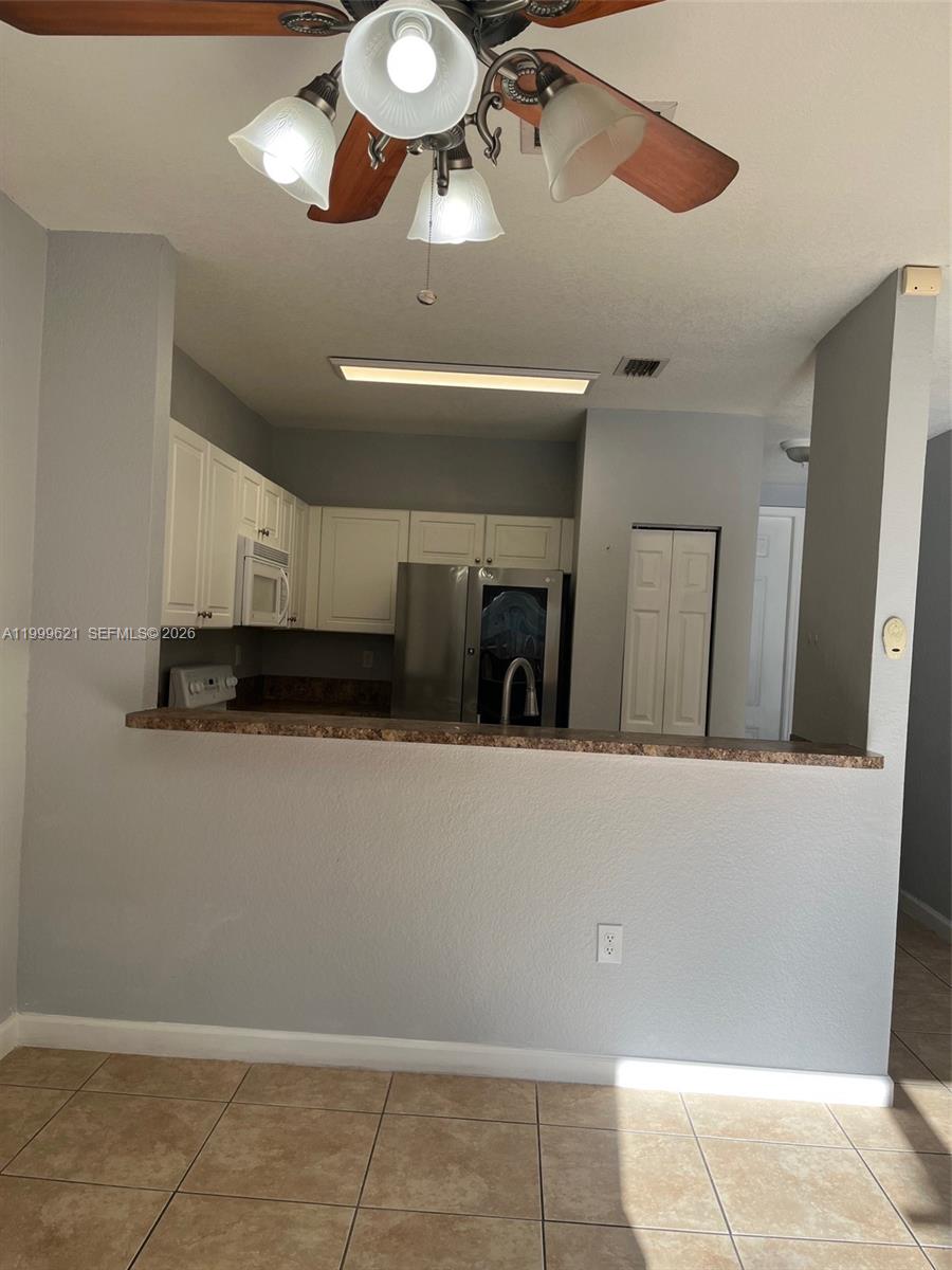 1650 Northeast 33rd Road, Unit 10610 Homestead, FL 33033 - Photo 8 of 22 a view of a livingroom with furniture and chandelier