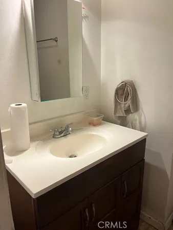 a kitchen with granite countertop a sink a window and cabinets
