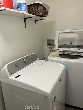 a kitchen with granite countertop a stove top oven cabinetry a sink and a counter top space