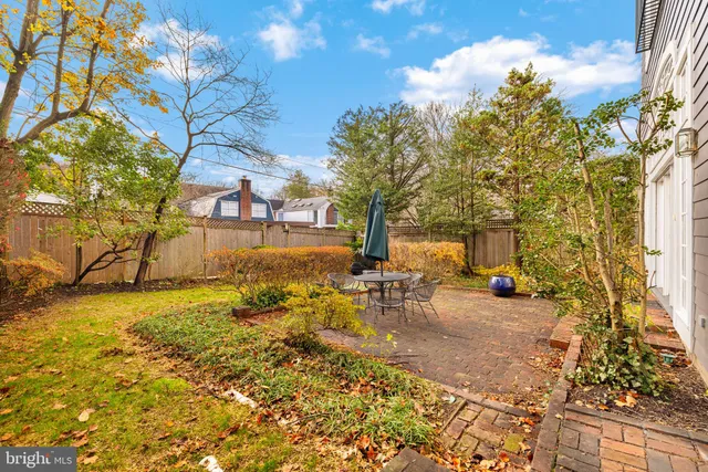 a view of a backyard with table and chairs and potted plants