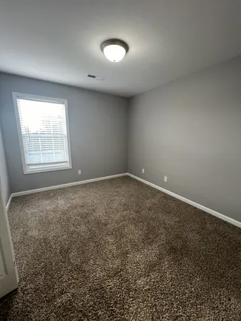an empty room with a empty space and windows