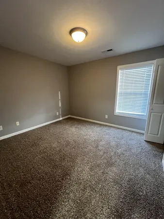 an empty room with a empty space and windows