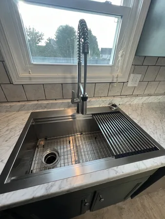 a close view of a stove a sink and dishwasher in a kitchen