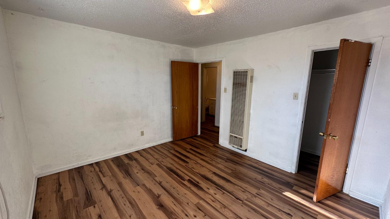 1014 Ave M Ralls, TX 79357 - Photo 8 of 13 a view of an empty room with wooden floor and a window