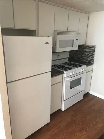 a white refrigerator freezer sitting inside of a kitchen