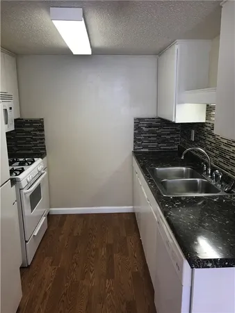 a kitchen that has a sink and a stove